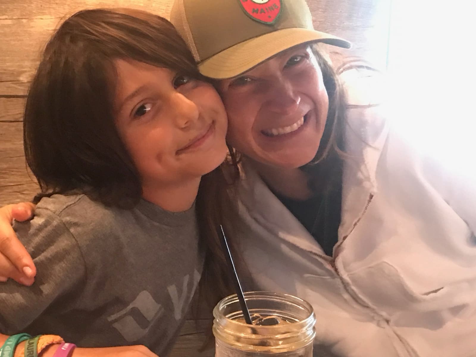 Mom and Mack - close, mid-laugh, sharing a drink.