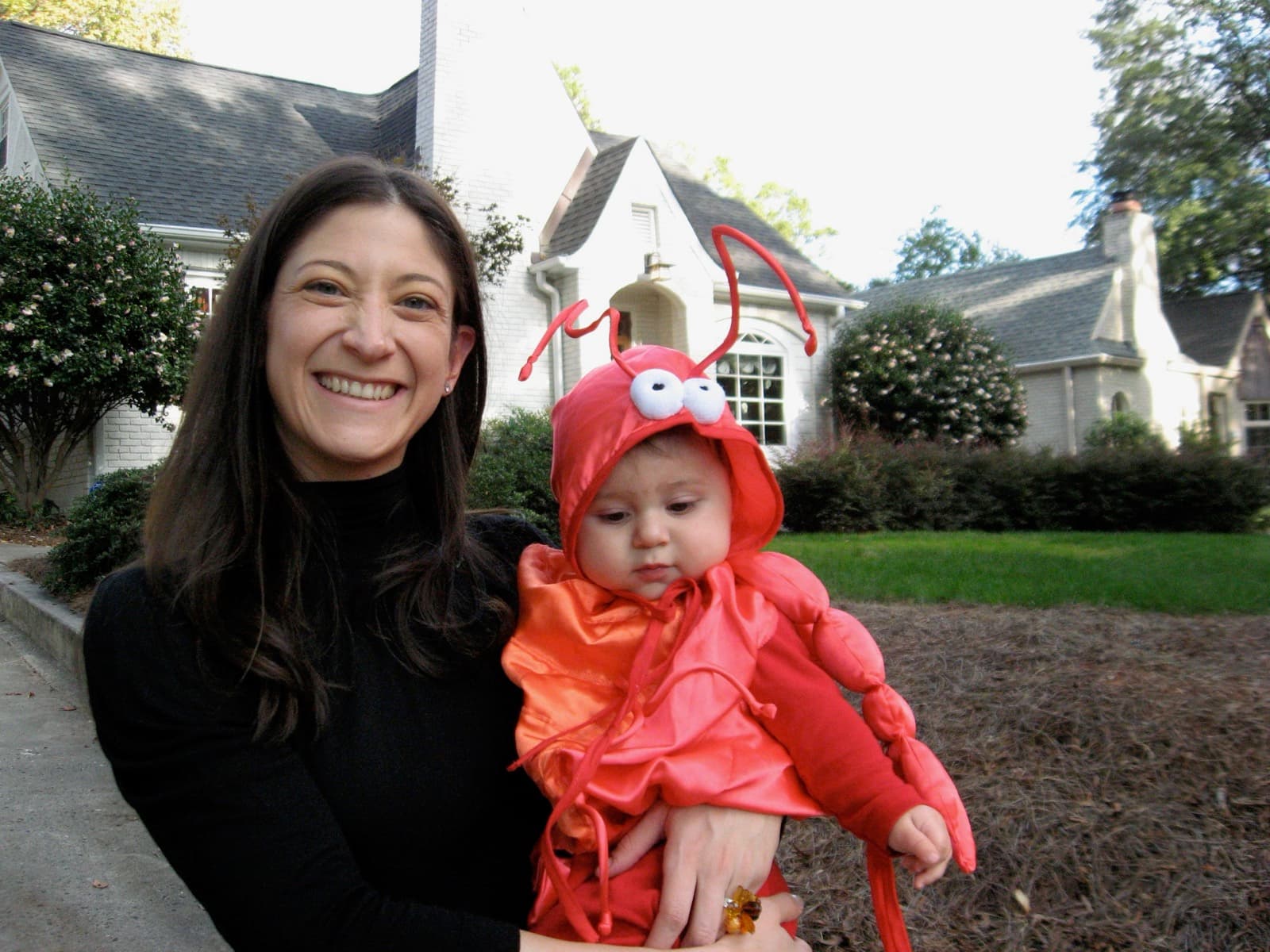 Mom holding baby Mack in a lobster Halloween costume.